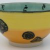 This bowl is a good size for serving small portions of things. It measures approximately, 5" in diameter x 2 3/4" tall. The outside is Tangerine on the bottom and Buttercup on the top. It has a random abstract black line drawing design with turquoise accents. The inside is Sea Grass on Top and Red on the bottom and has an open flower and more abstract line drawings.