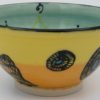 This bowl is a good size for serving small portions of things. It measures approximately, 5" in diameter x 2 3/4" tall. The outside is Tangerine on the bottom and Buttercup on the top. It has a random abstract black line drawing design with turquoise accents. The inside is Sea Grass on Top and Red on the bottom and has an open flower and more abstract line drawings.
