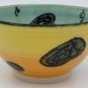 This bowl is a good size for serving small portions of things. It measures approximately, 5" in diameter x 2 3/4" tall. The outside is Tangerine on the bottom and Buttercup on the top. It has a random abstract black line drawing design with turquoise accents. The inside is Sea Grass on Top and Red on the bottom and has an open flower and more abstract line drawings.
