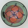 This bowl is a good size for serving small portions of things. It measures approximately, 5" in diameter x 2 3/4" tall. The outside is Tangerine on the bottom and Buttercup on the top. It has a random abstract black line drawing design with turquoise accents. The inside is Sea Grass on Top and Red on the bottom and has an open flower and more abstract line drawings.